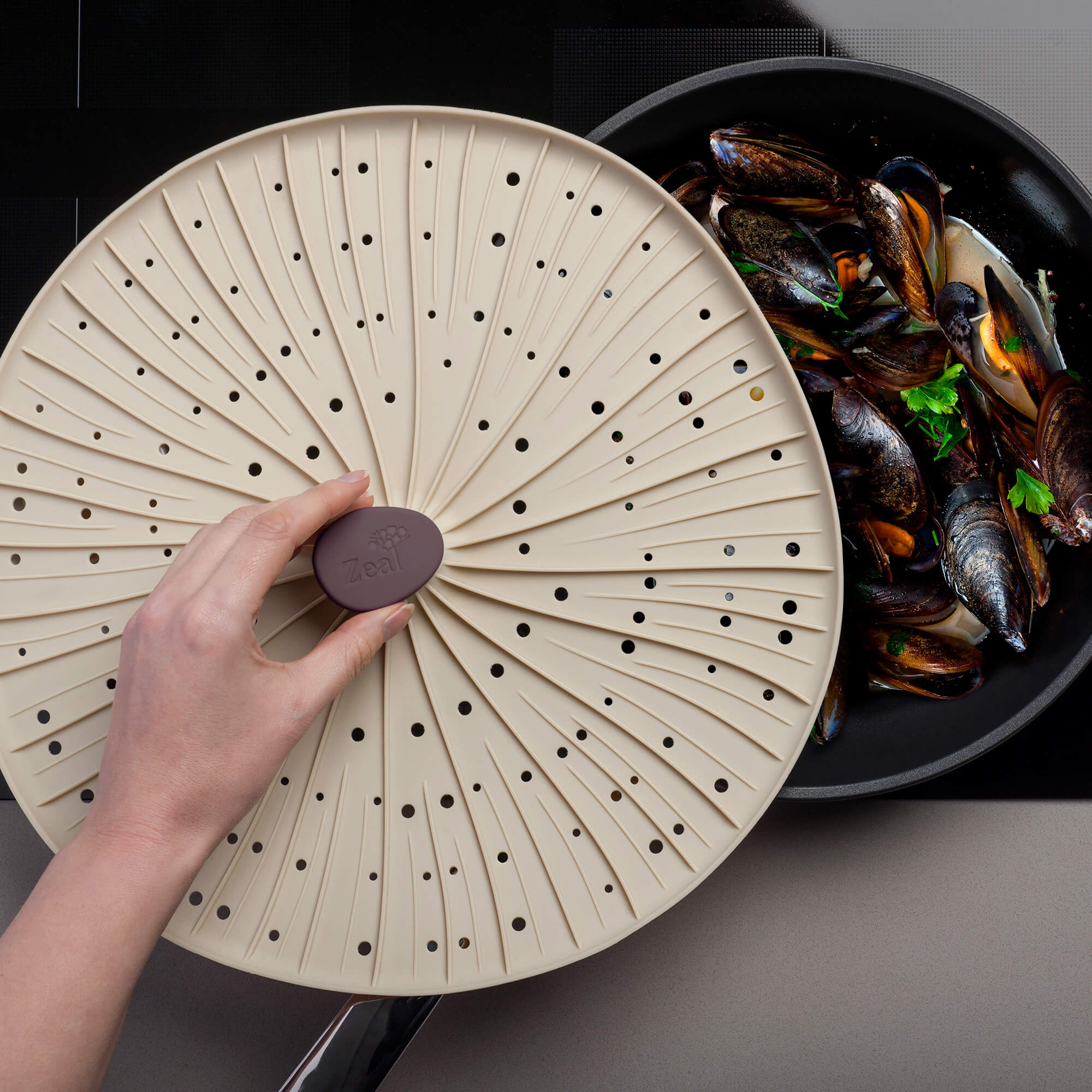 Zeal Mushroom Silicone Splatter Guard in use cooking mussels