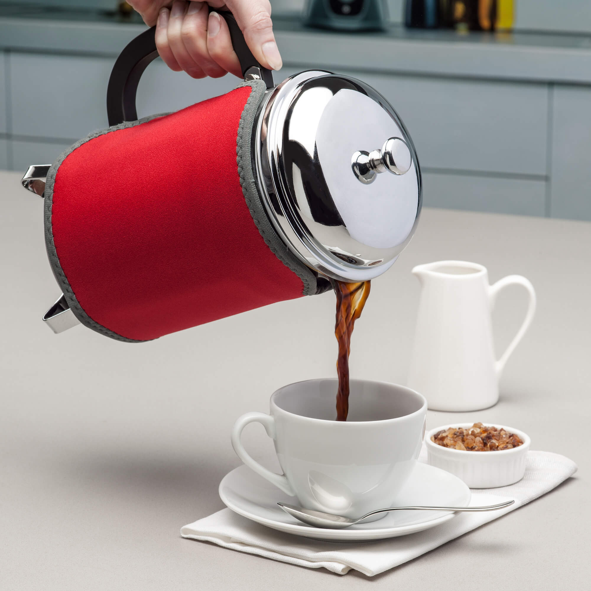 Pouring coffee using the Zeal 12 Cup Cafetiere Jacket