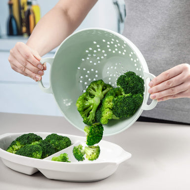 Tipping drained broccoli from Zeal Melamine Colander