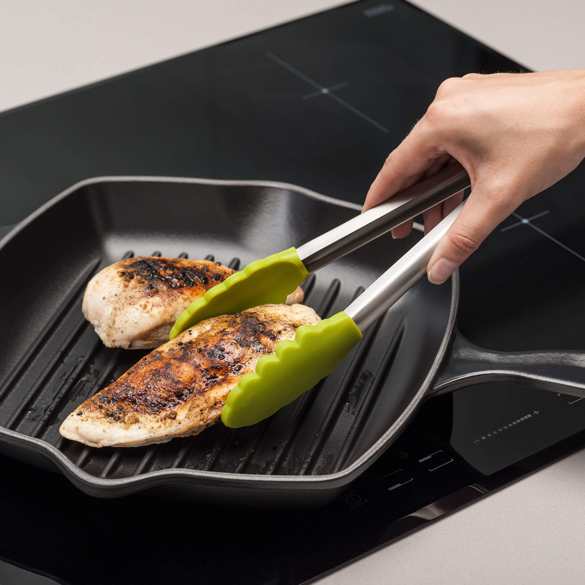Using a Zeal Silicone Cook’s Tong to turn cooking chicken