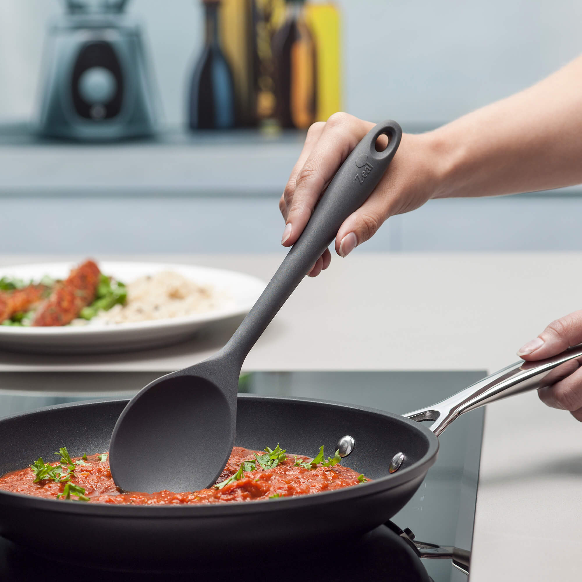 Zeal Silicone Cook’s Spoon in Dark Grey stirring sauce