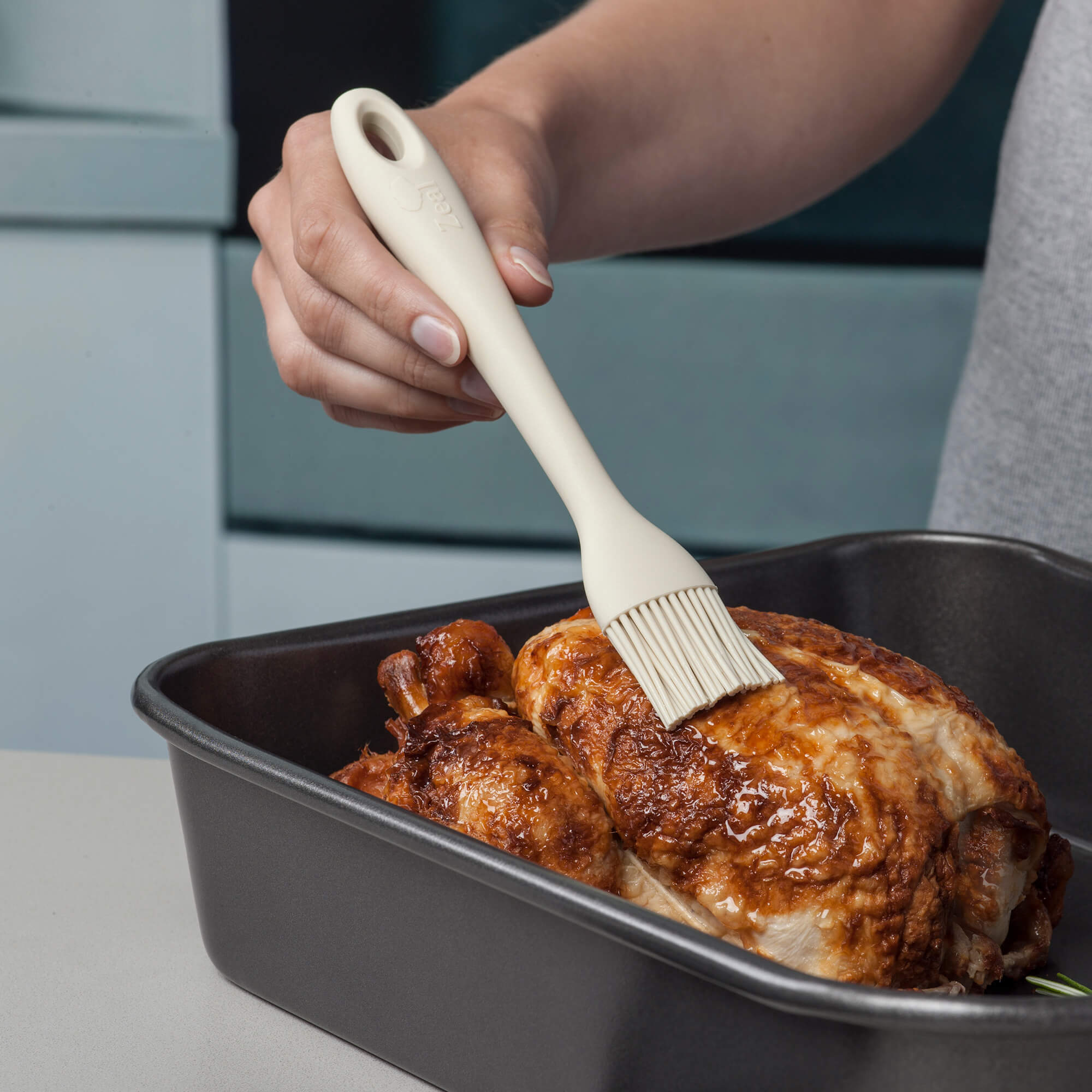 Using a Zeal Silicone Pastry Brush to baste chicken