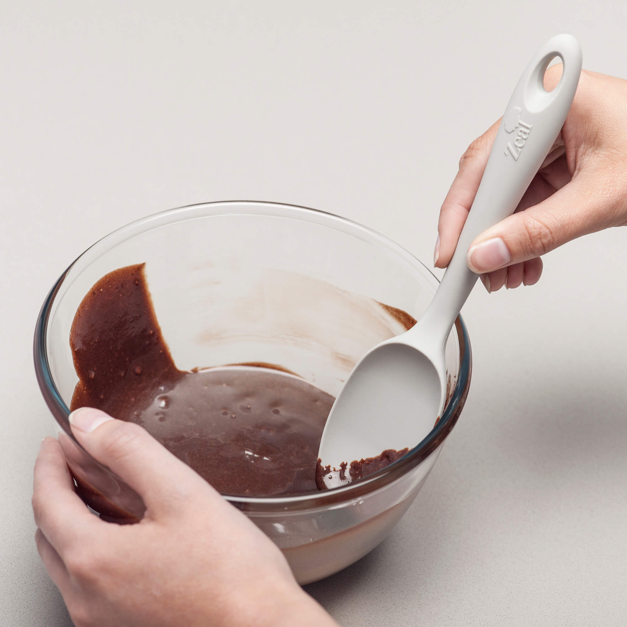 Using a Zeal Silicone Spatula Spoon to scrape a bowl