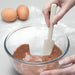 Using a Zeal Silicone Mini Baking Spatula to scrape a bowl