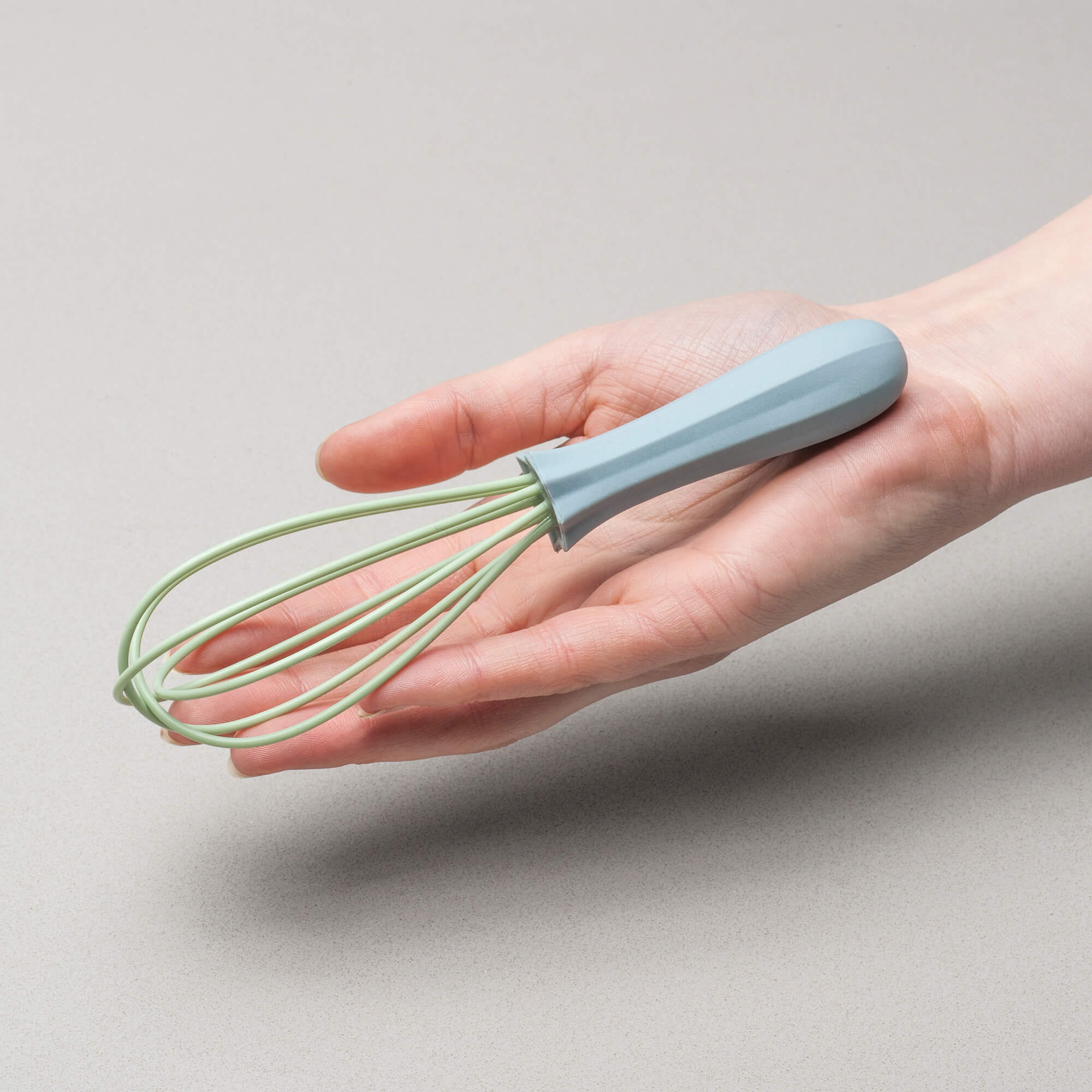 Silicone Mini Sauce Whisk in hand to show scale