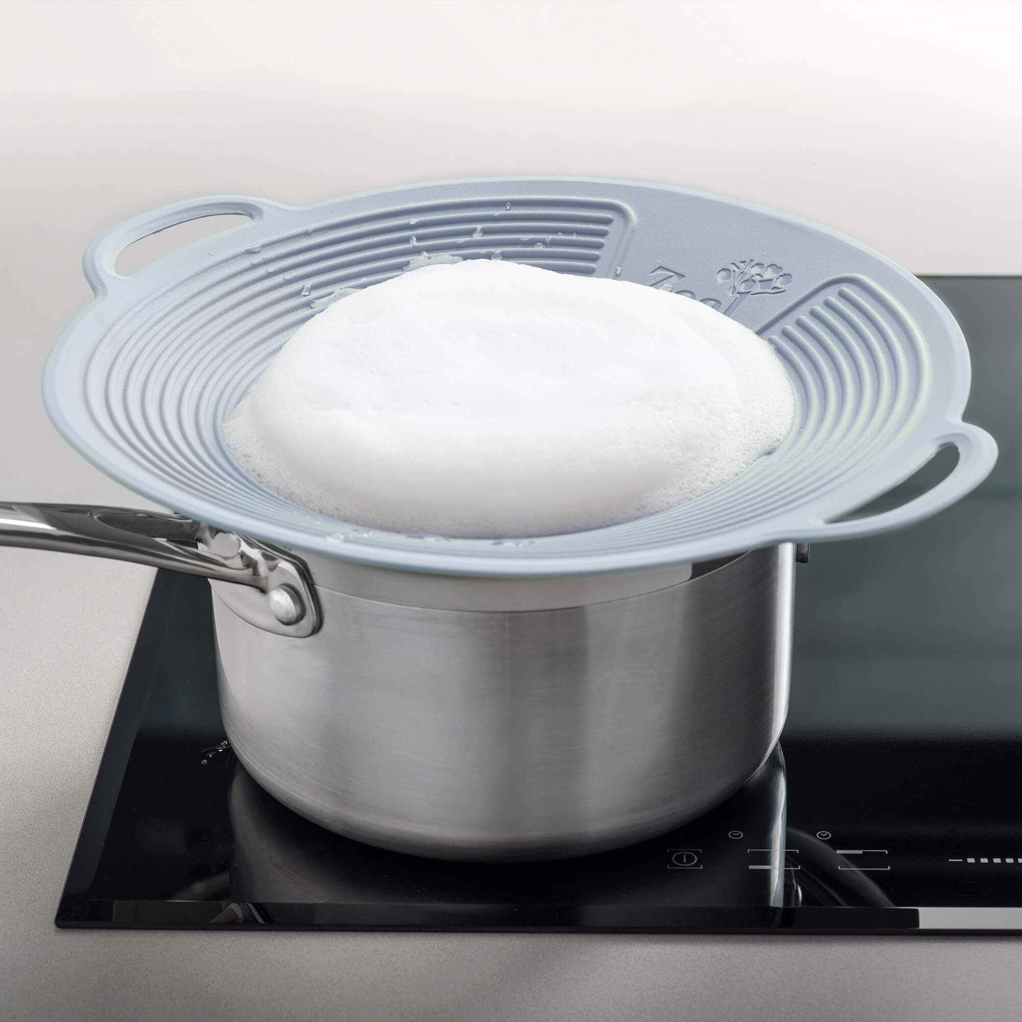 Silicone Boil Over Lid by Zeal used on a saucepan