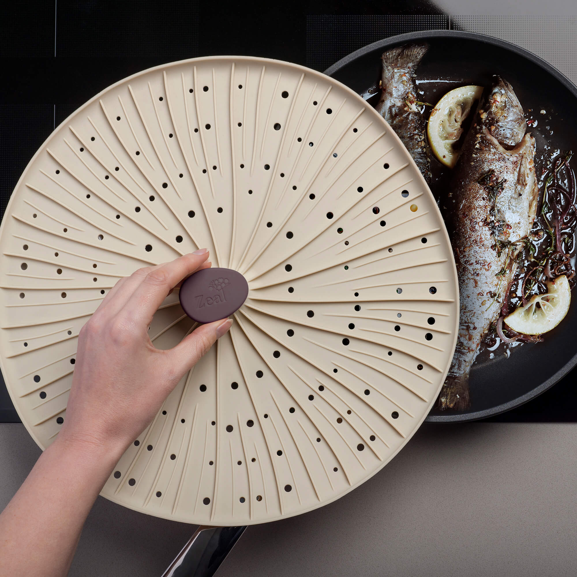 Zeal Mushroom Silicone Splatter Guard in use cooking fish