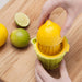 Squeezing a fresh lemon using a Zeal Citrus Juicer