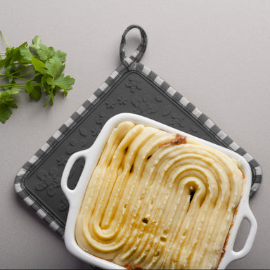 Silicone Square Shaped Hot Mat and Grab used as a trivet under cottage pie