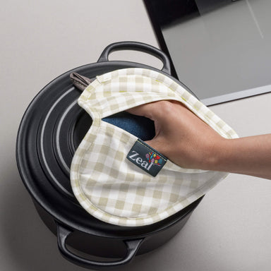 Heart Shaped Hot Mat and Grab by Zeal taking off casserole lid