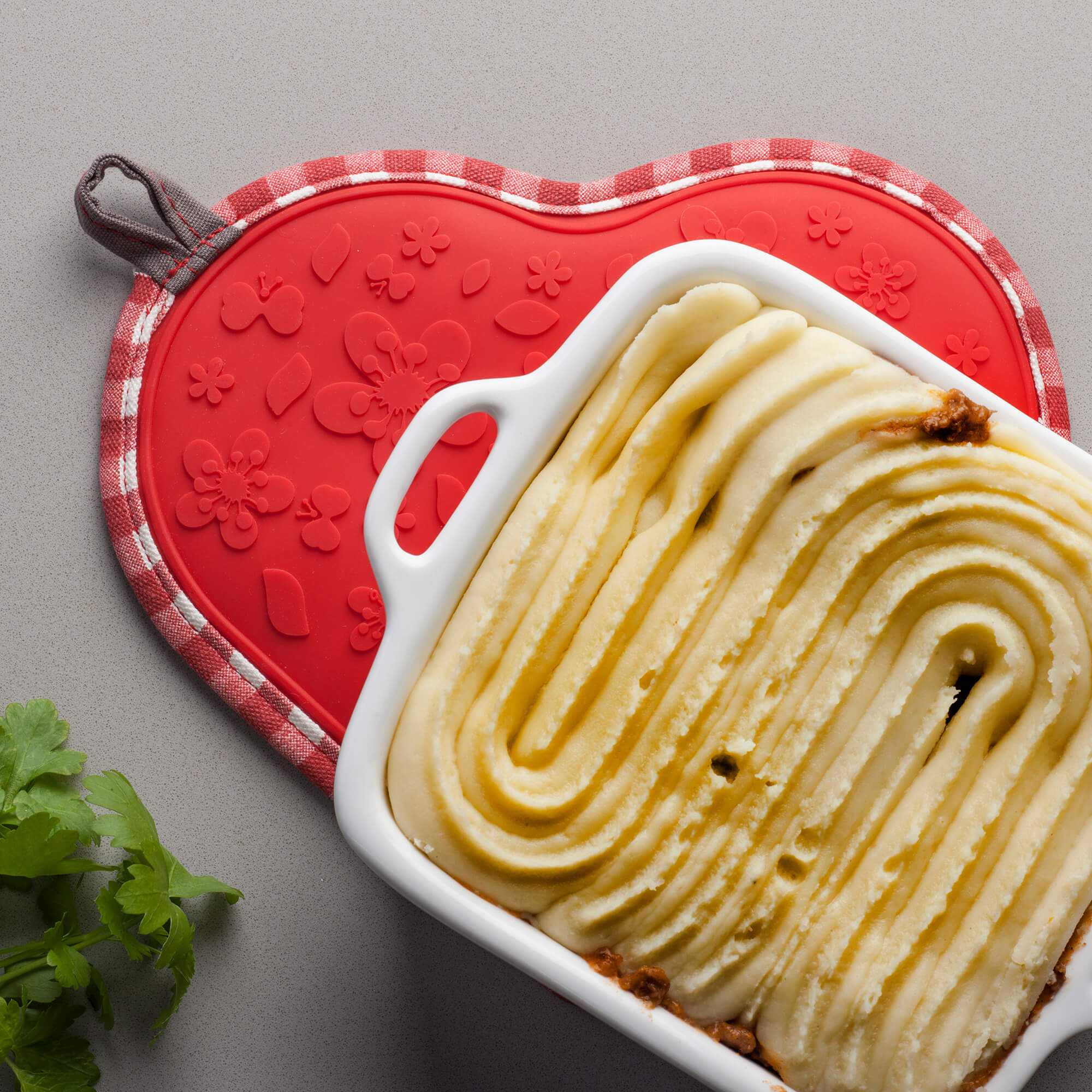 Silicone Heart Shaped Hot Mat and Grab used as a trivet under cottage pie